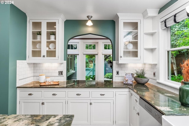 kitchen featuring white cabinets, dishwasher, and dark stone counters