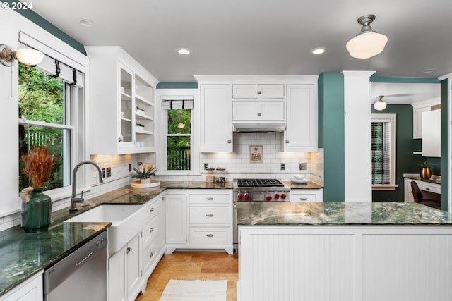 kitchen with appliances with stainless steel finishes, tasteful backsplash, and a healthy amount of sunlight