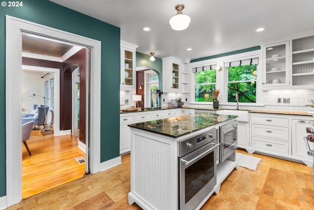 kitchen with sink, white cabinets, and stainless steel appliances