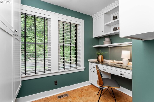 office area with built in desk and a healthy amount of sunlight