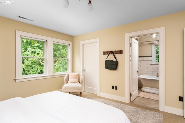 bedroom featuring connected bathroom and tile walls