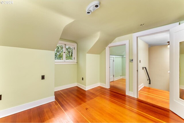 bonus room featuring wood-type flooring and vaulted ceiling