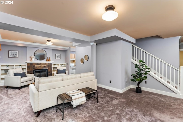 living room with carpet flooring and a tile fireplace