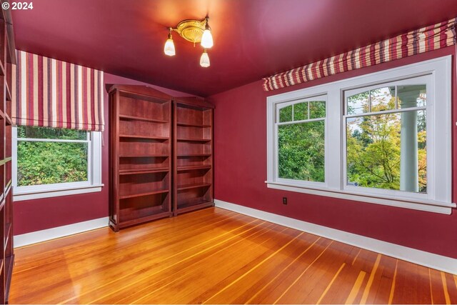 unfurnished bedroom featuring hardwood / wood-style flooring and ceiling fan