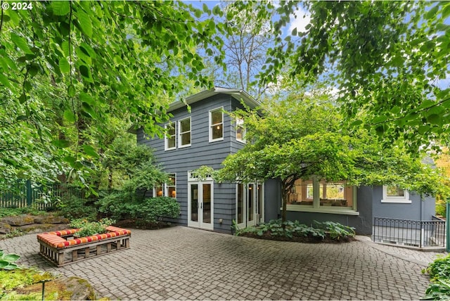 rear view of house with french doors and a patio