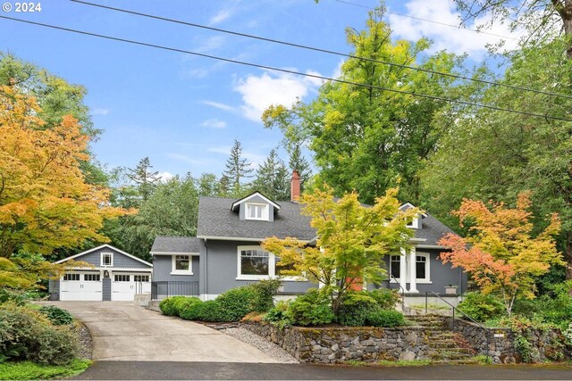 view of front of property with an outdoor structure and a garage