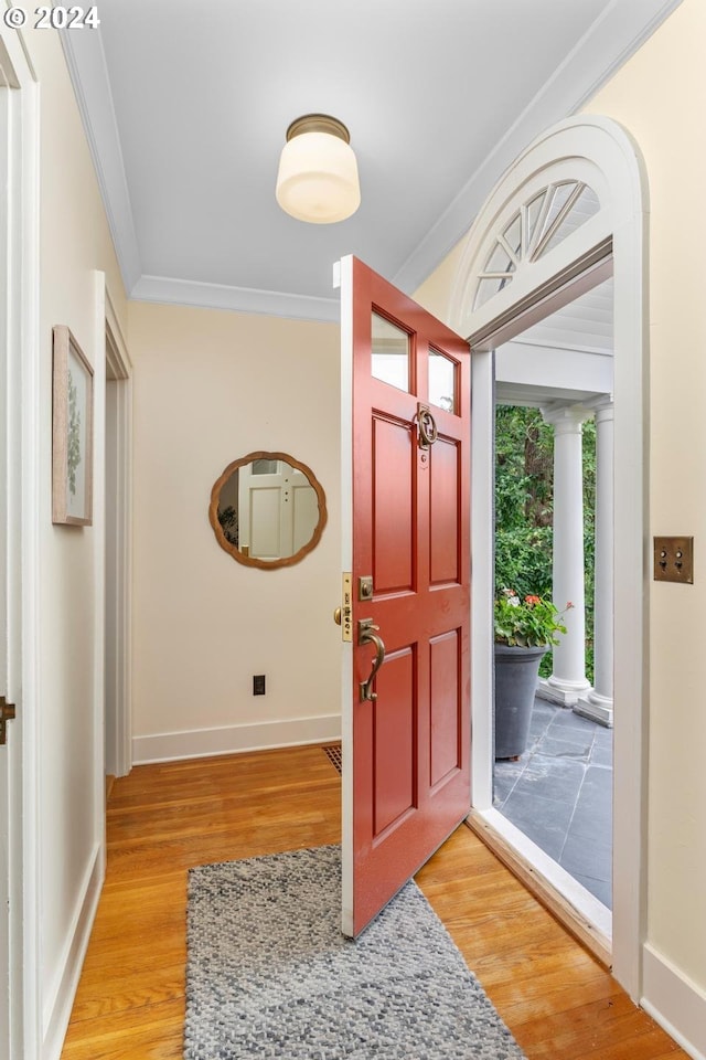 entryway featuring hardwood / wood-style floors and ornamental molding