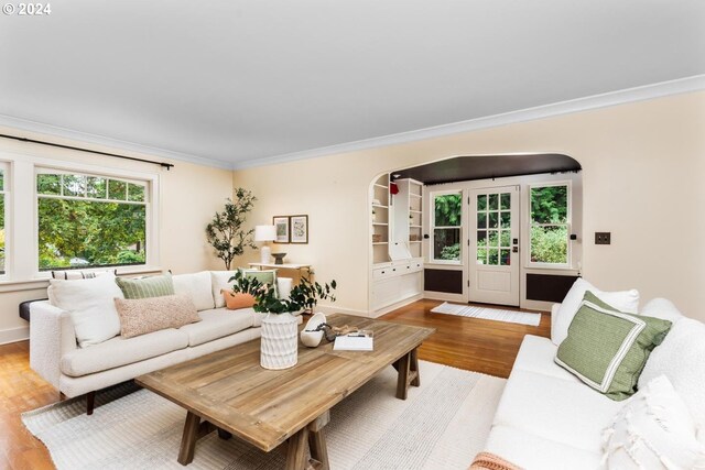 living room with light hardwood / wood-style floors and ornamental molding