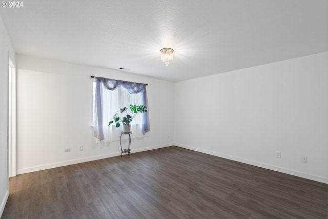 empty room featuring dark hardwood / wood-style flooring