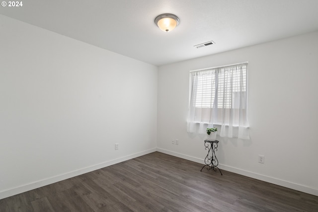 unfurnished room with dark hardwood / wood-style floors