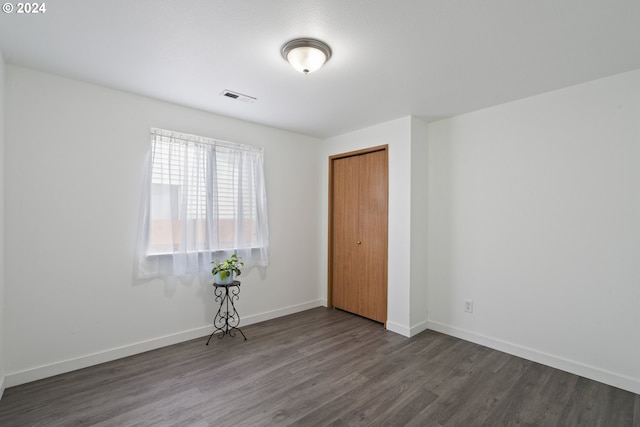 empty room with dark wood-type flooring