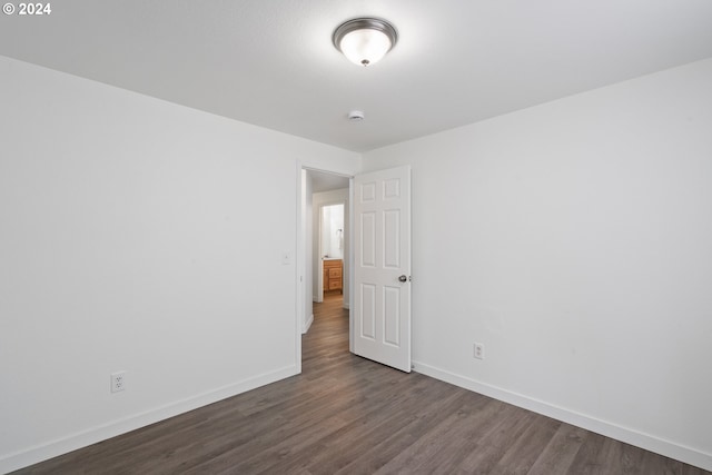 spare room with dark hardwood / wood-style flooring