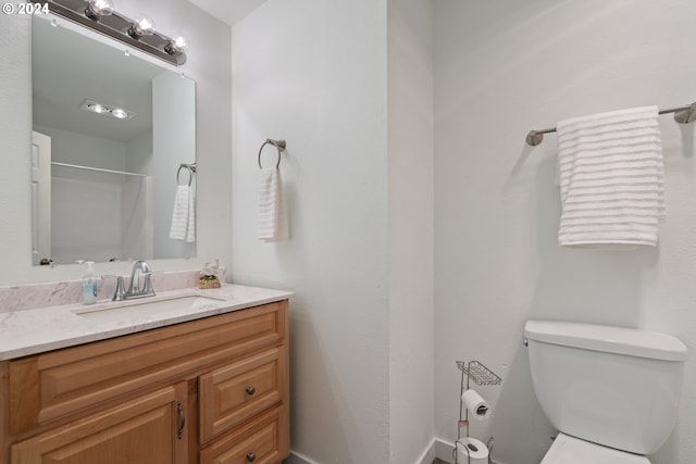 bathroom with toilet and vanity