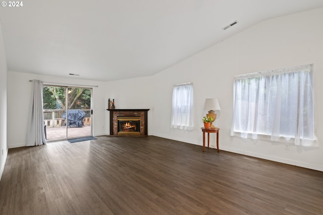 unfurnished living room featuring dark hardwood / wood-style floors and vaulted ceiling