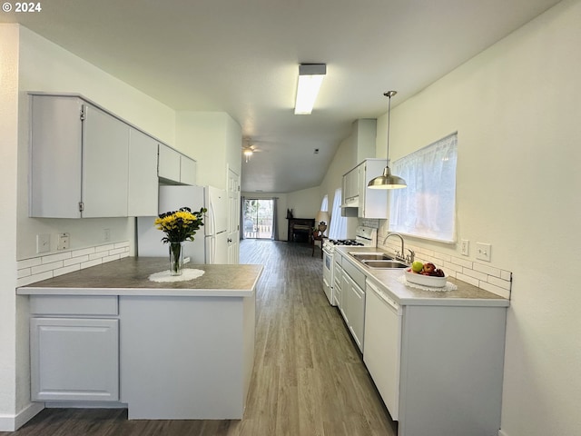 kitchen featuring white cabinets, hanging light fixtures, wood-type flooring, and white appliances