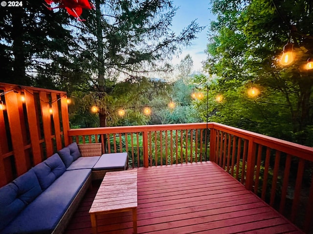 deck at dusk featuring outdoor lounge area