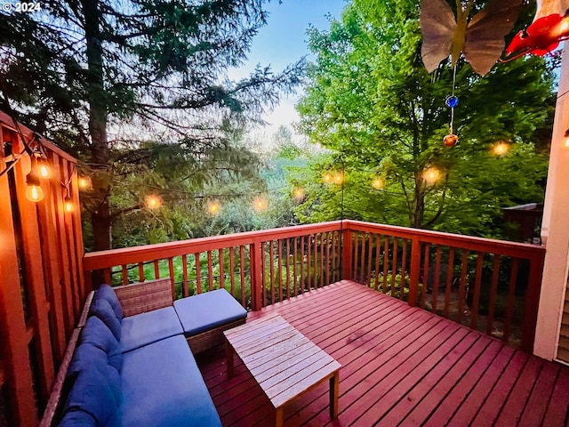 deck at dusk with outdoor lounge area