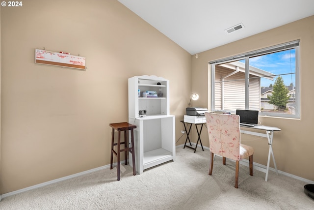 carpeted home office with lofted ceiling