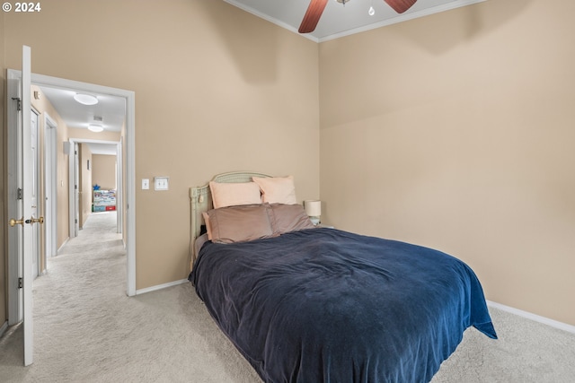 bedroom featuring light colored carpet, ceiling fan, and ornamental molding