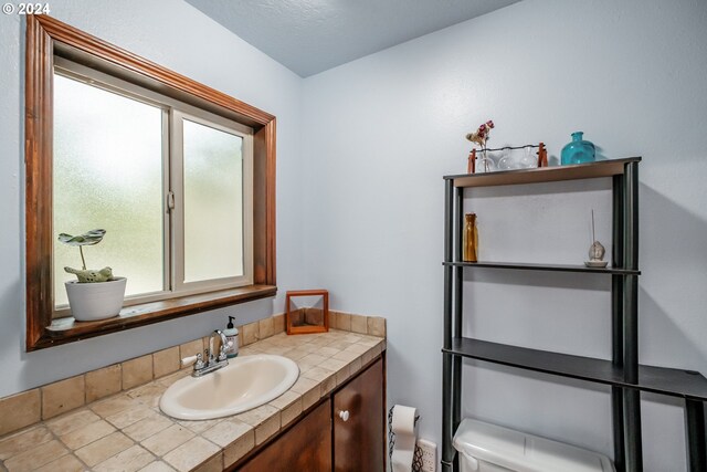 bathroom featuring vanity and toilet