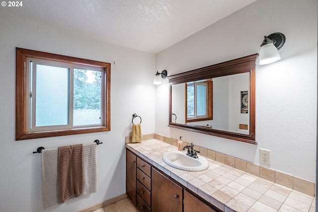 bathroom with tile patterned floors and vanity