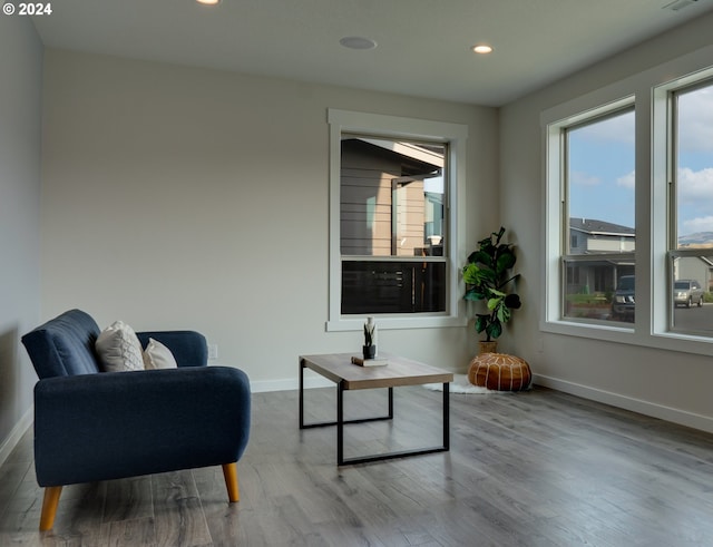 living area featuring recessed lighting, wood finished floors, visible vents, and baseboards