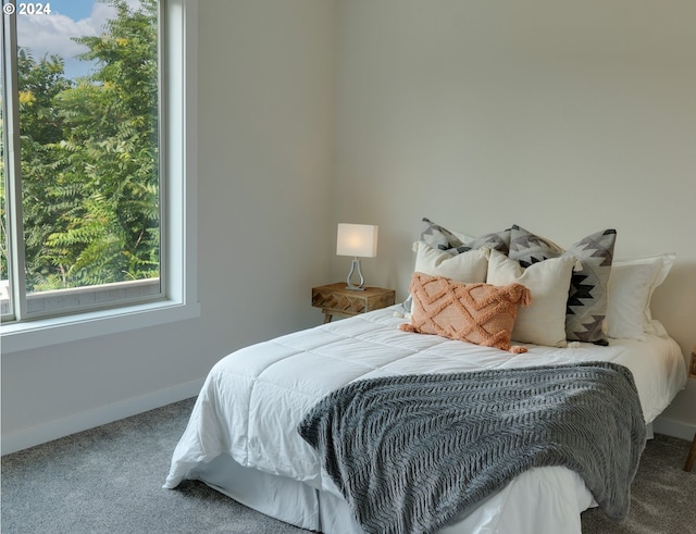 carpeted bedroom featuring baseboards