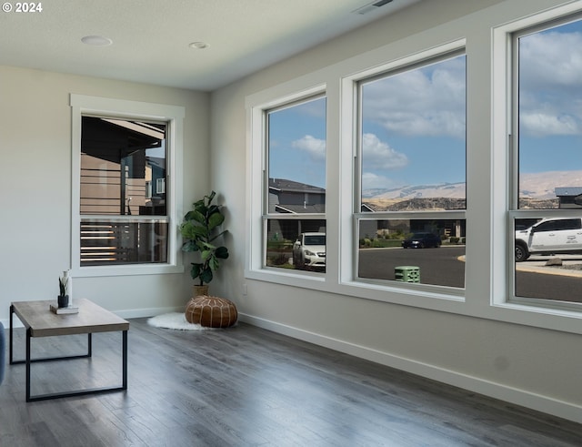 interior space with a wealth of natural light and a mountain view