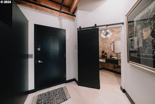 foyer entrance featuring brick wall and a barn door