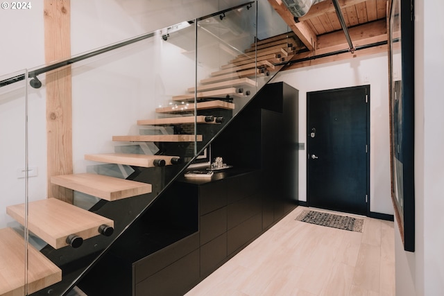 stairway featuring hardwood / wood-style flooring