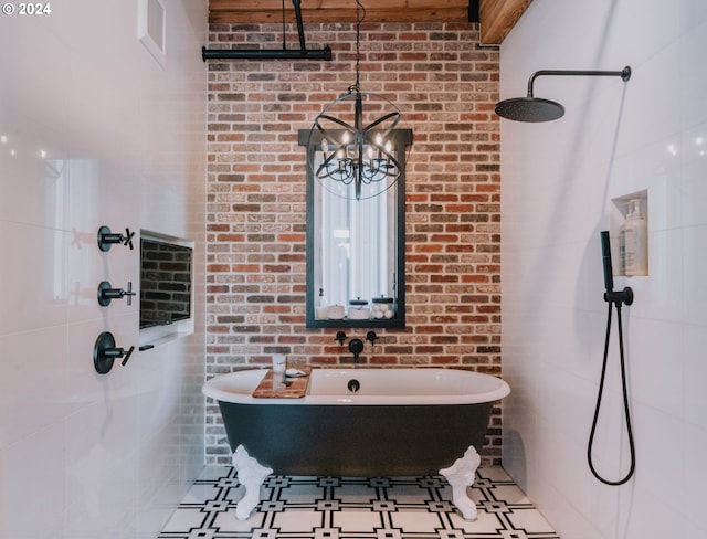 bathroom with a notable chandelier and brick wall