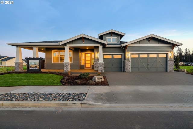 craftsman inspired home with a front yard and a garage