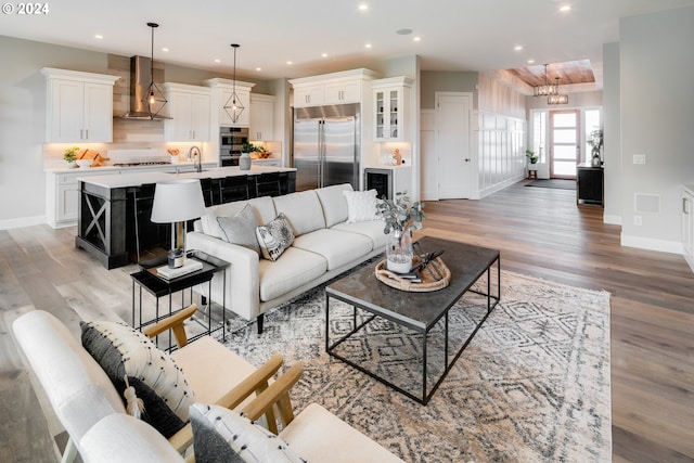 living room with hardwood / wood-style floors and sink