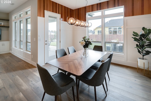 dining space with a wealth of natural light and light hardwood / wood-style floors