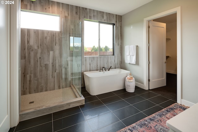 bathroom with shower with separate bathtub and tile floors