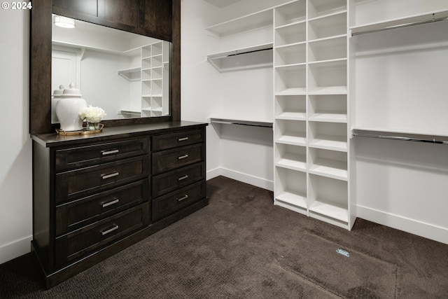 spacious closet featuring dark carpet