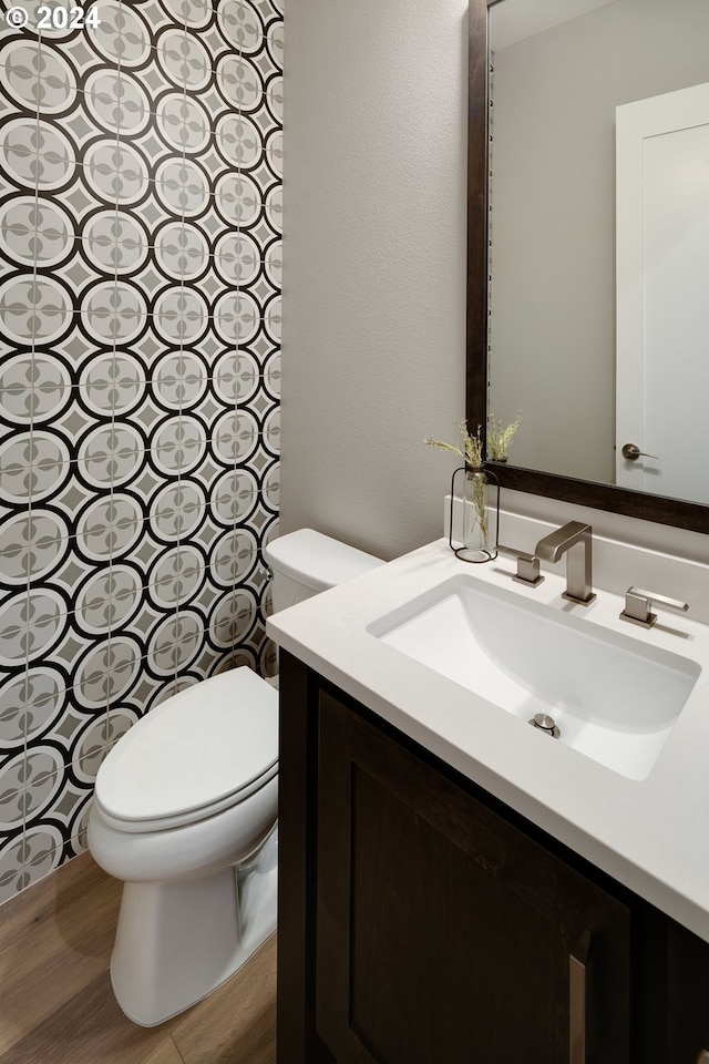 bathroom with tile floors, vanity, and toilet