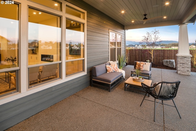 patio terrace at dusk featuring an outdoor hangout area