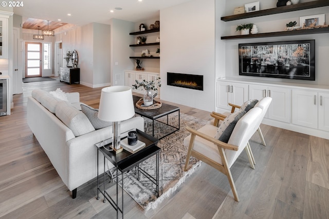 living room with light hardwood / wood-style flooring and a large fireplace