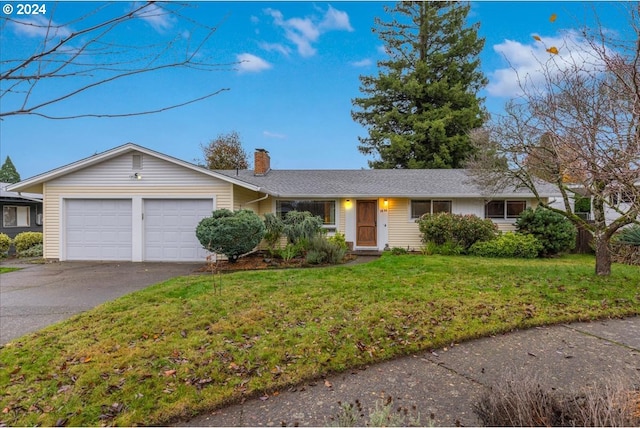 single story home featuring a front yard and a garage