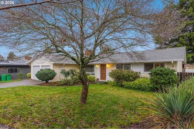 ranch-style home with a garage and a front yard