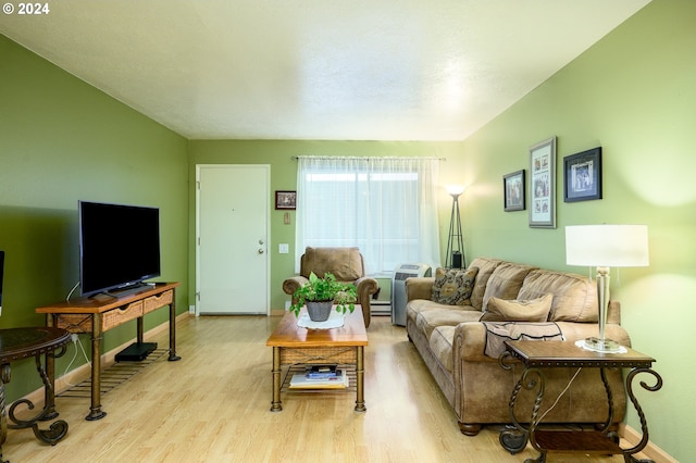living room with light wood-style flooring, baseboards, and a baseboard radiator