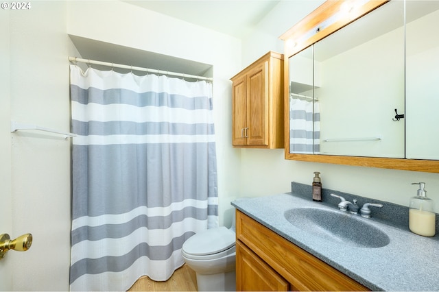 bathroom with toilet, hardwood / wood-style floors, a shower with curtain, and vanity