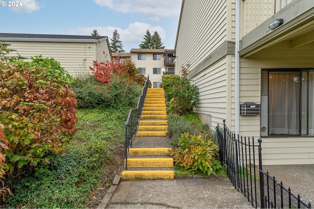 view of yard with stairs and fence