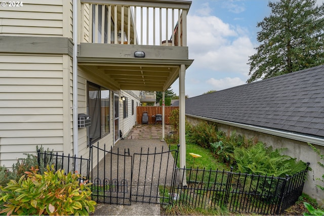 exterior space featuring fence private yard, a balcony, and a gate