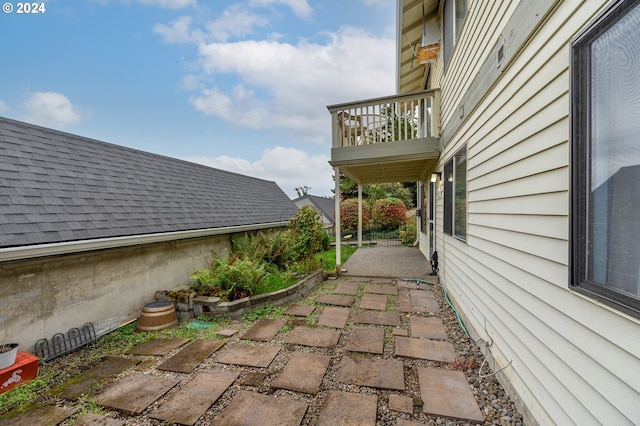 view of home's exterior with a patio area and a balcony