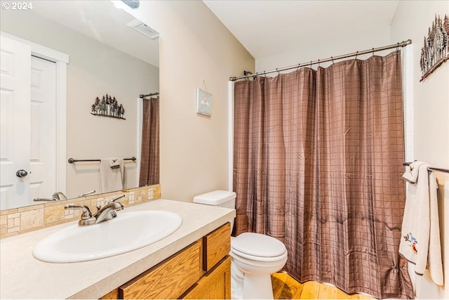 bathroom with vanity, toilet, and walk in shower