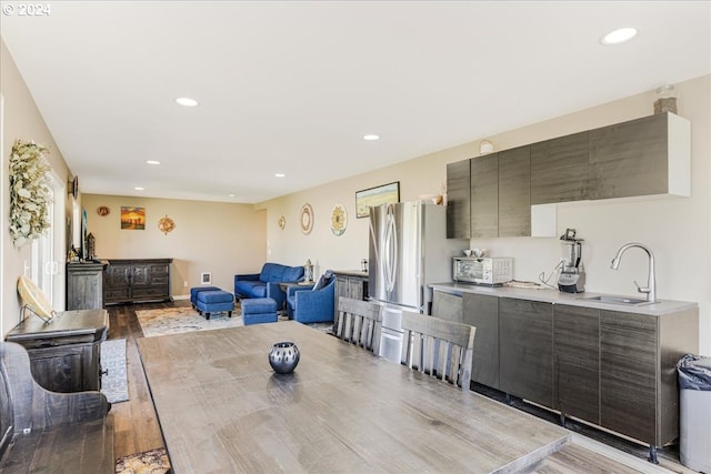 dining area featuring light wood-type flooring and sink