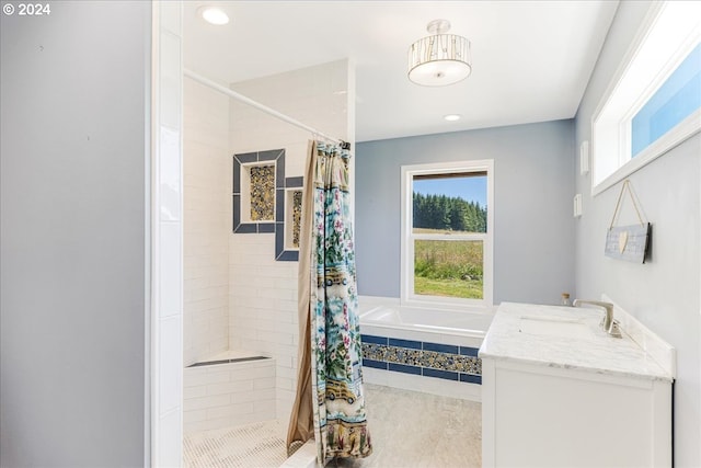 bathroom featuring tile patterned floors, vanity, curtained shower, and a wealth of natural light