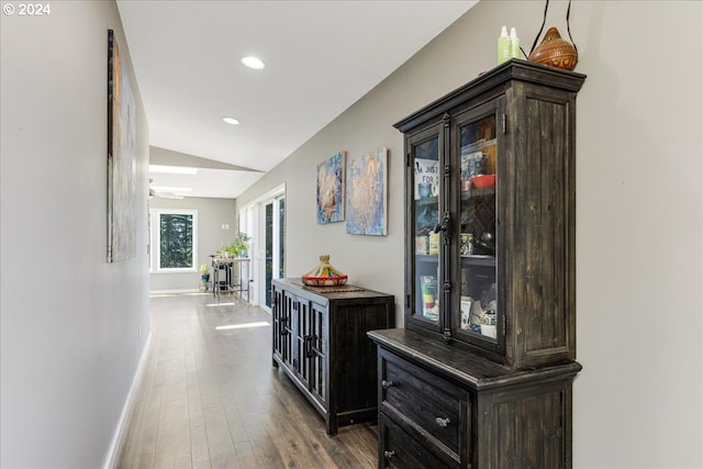 hall with hardwood / wood-style floors and lofted ceiling